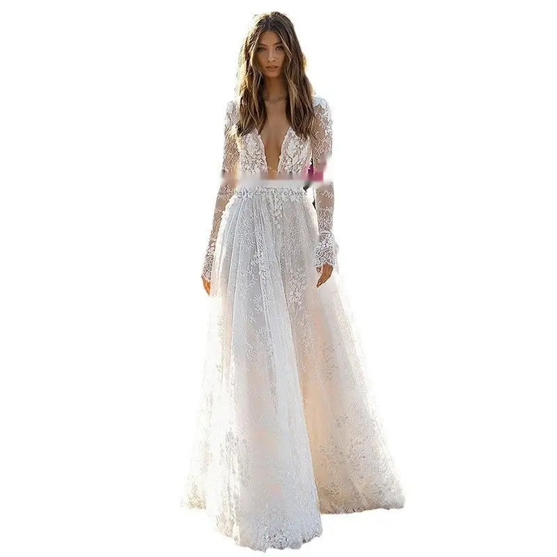 a flowing white wedding dress lace gown with long sleeves and a deep v-neckline designed for bridal wear