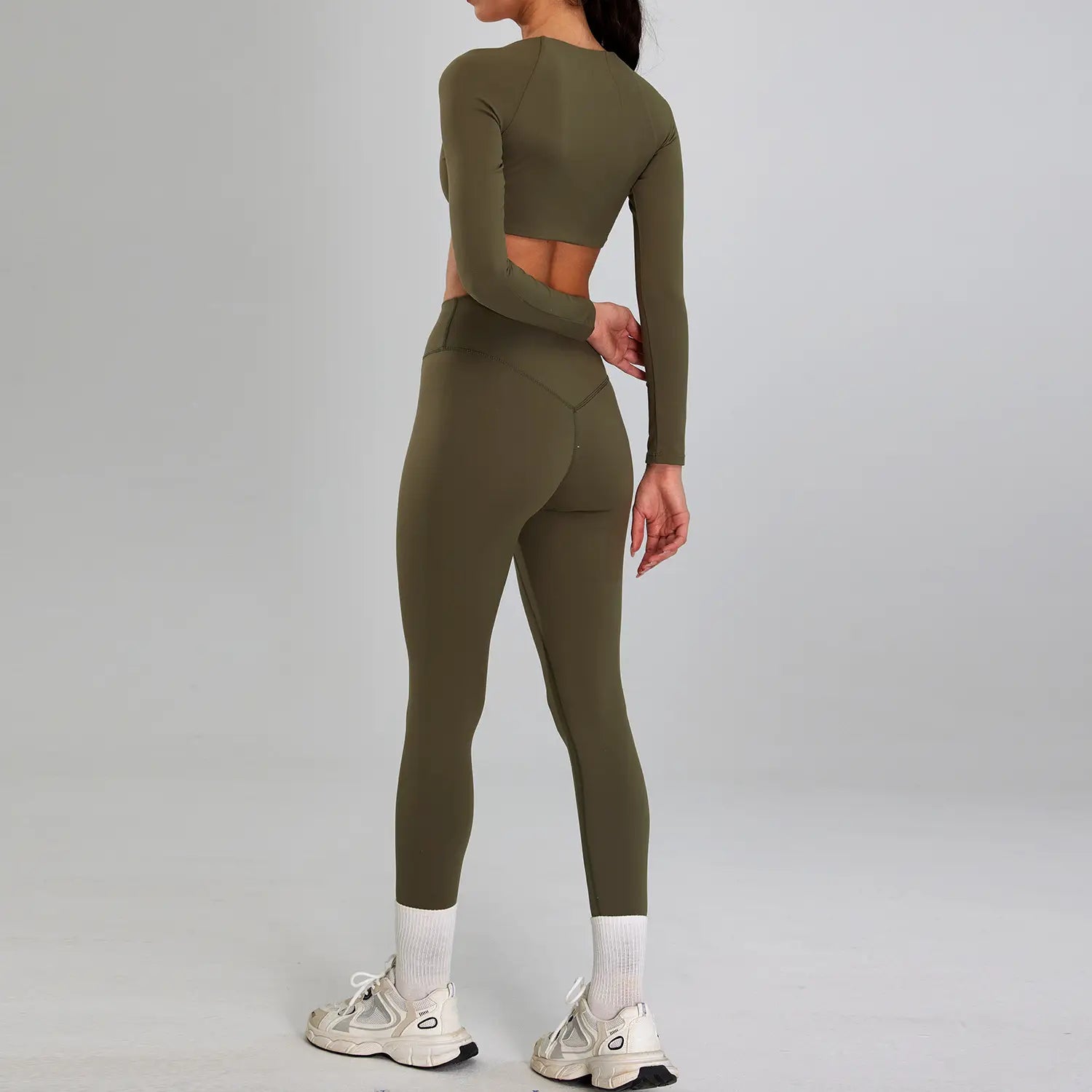 olive green long-sleeved crop top and matching high-waisted leggings set designed for outdoor running nude as a sports suit outdoor essential