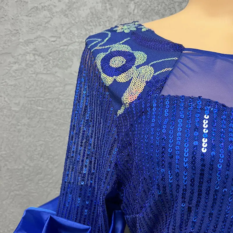 A vibrant royal blue half sleeve slim fit evening dress with round neck shirt design, featuring sequined fabric, intricate floral embroidery, and sheer mesh detailing.