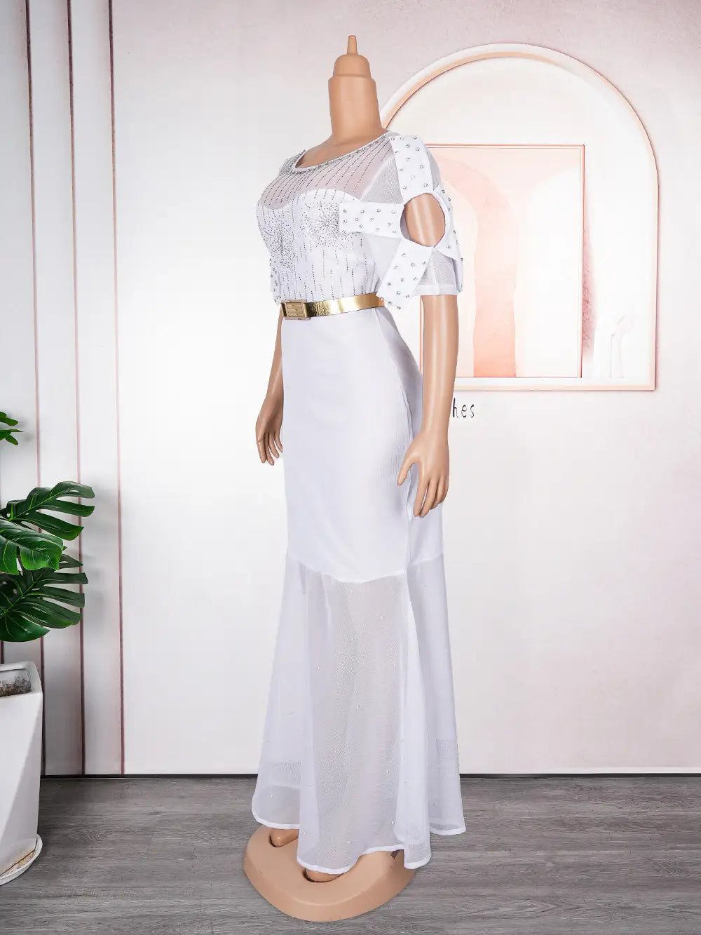 white sheer two-piece dress featuring a beaded bodice and gold belt paired with a royal blue heavy embroidered hot diamond beads gown