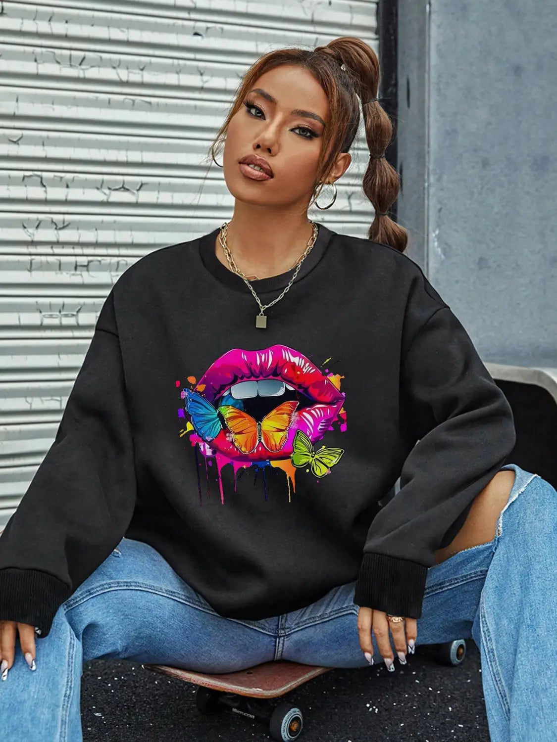black crew neck sweatshirt featuring a vibrant dripping rainbow lip print with colorful butterflies designed on the front for a stylish and comfortable neck sweatshirt.