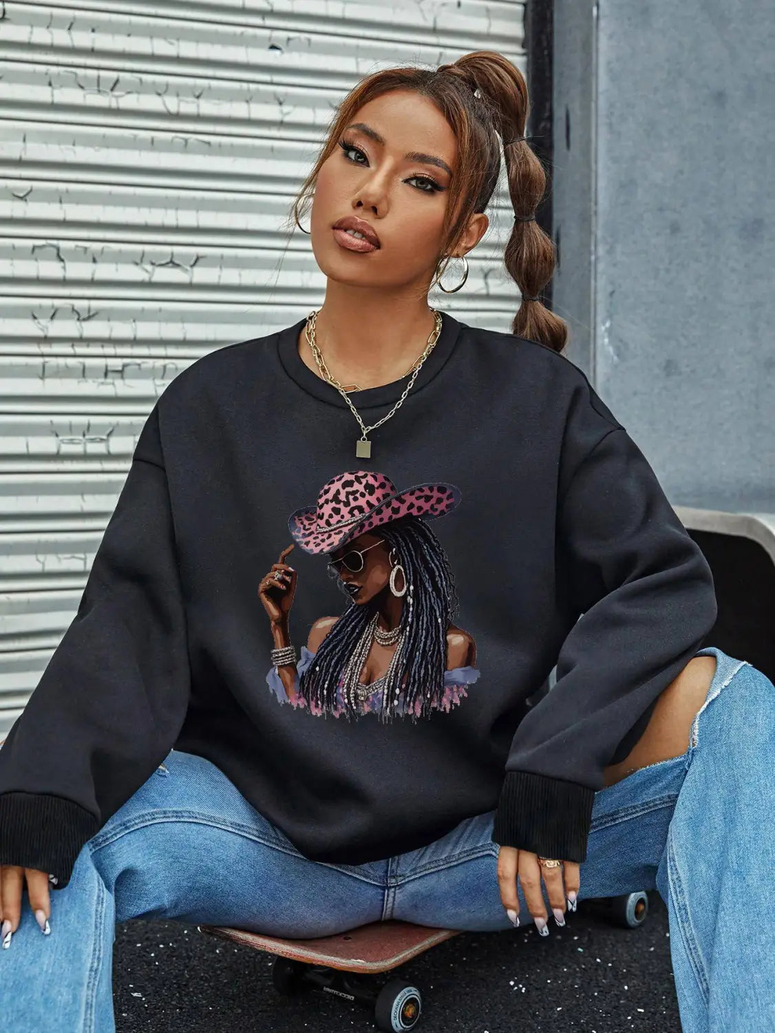 black oversized long sleeve sweatshirt featuring a vibrant graphic of a woman in a pink leopard-print hat and sunglasses