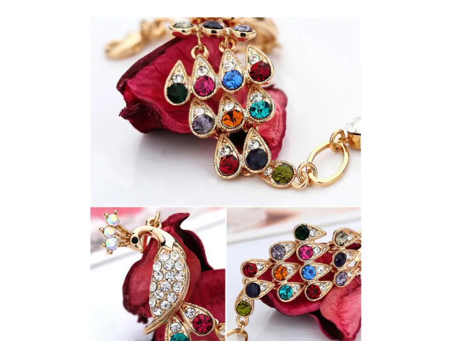 Gold-toned peacock-themed keychain adorned with vibrant red, blue, green, and orange teardrop-shaped rhinestones from the creative crystal peacock bridal jewelry set.