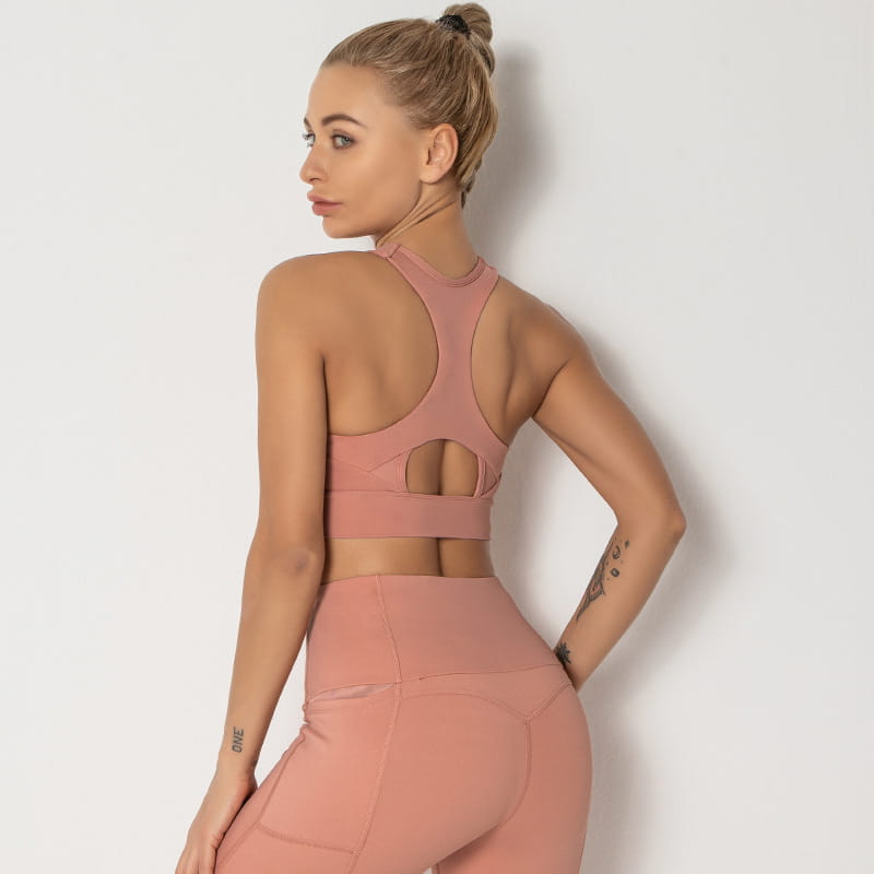 a sleek blush-pink high-neck women’s shockproof running sports bra with racerback design and cutout details ideal for shockproof running and shockproof running yoga
