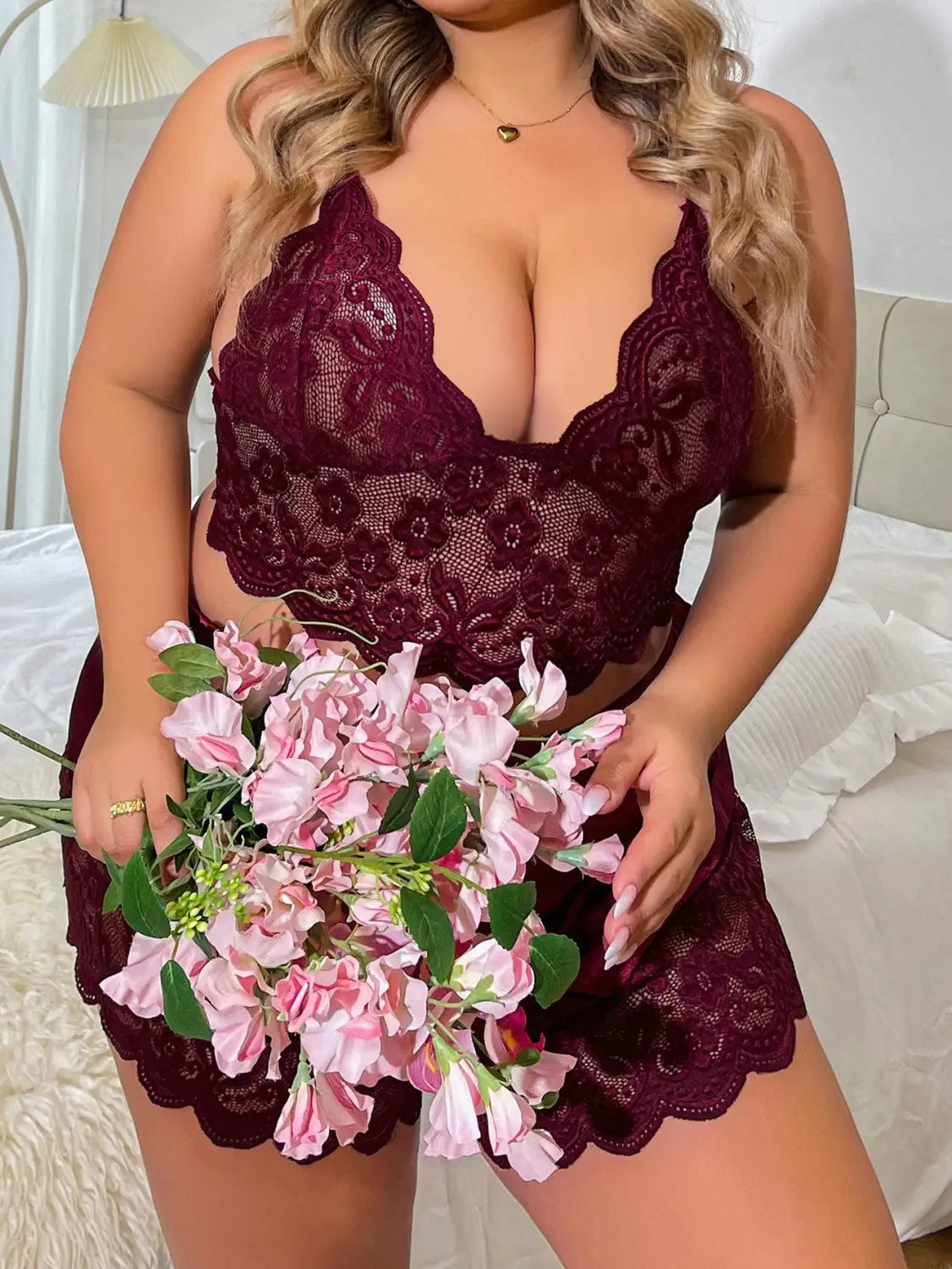 A maroon lace strap plus size two-piece suit featuring a lace strap design with intricate floral patterns and scalloped edges.