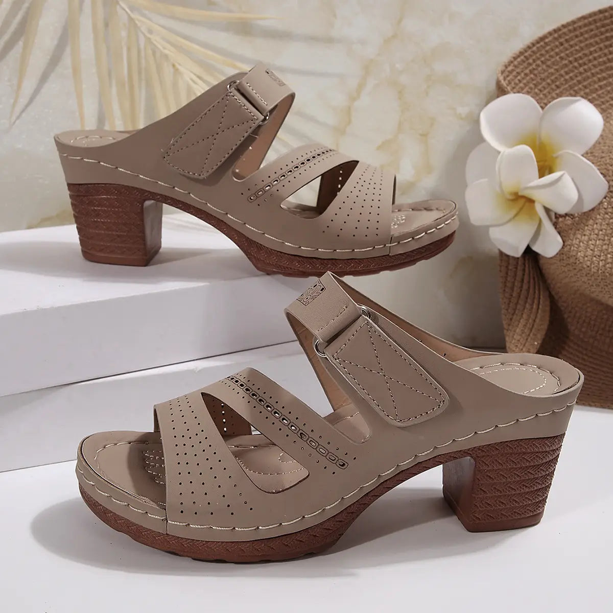 Beige leather mule sandals with perforated straps and a textured block heel designed as tan leather summer casual chunky shoes summer.