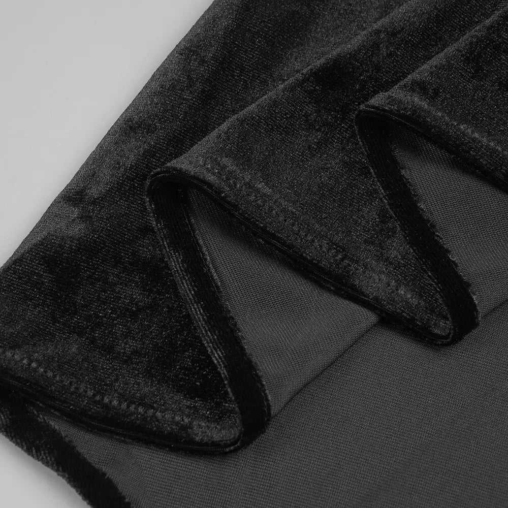 black velvet fabric with a plush textured surface and visible stitching along the folded edge of a black camisole backless slim fit velvet floral gown.