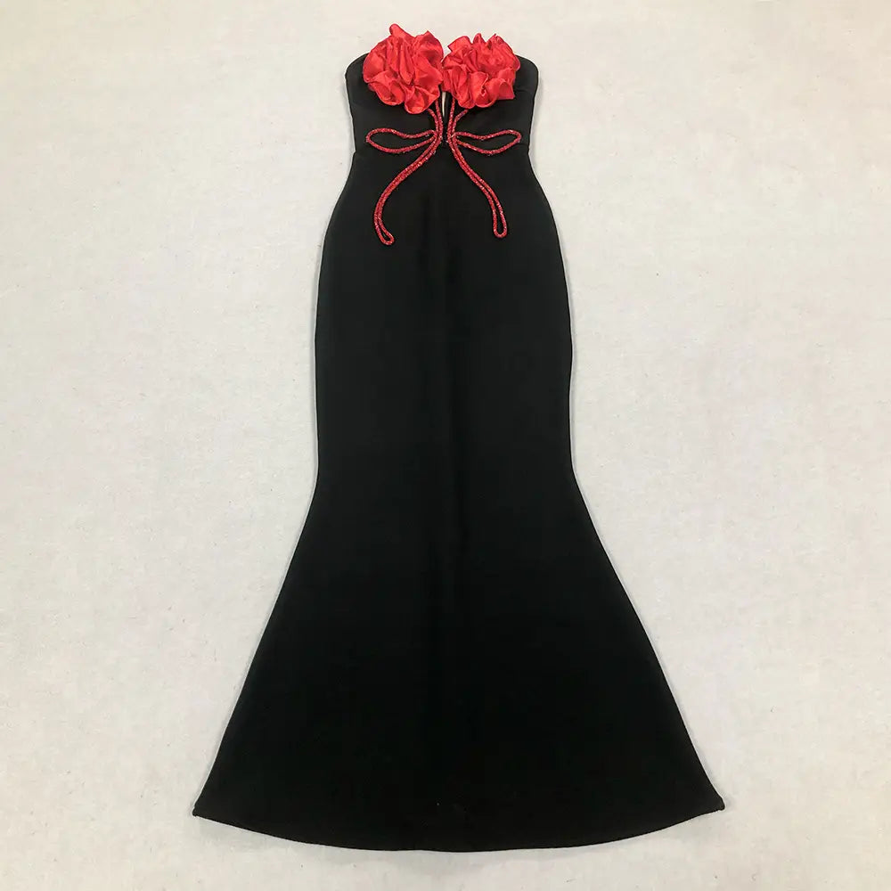 Black mermaid style temperament socialite dress featuring red fabric flowers and a matching embroidered bow at the neckline for elegant evening wear.