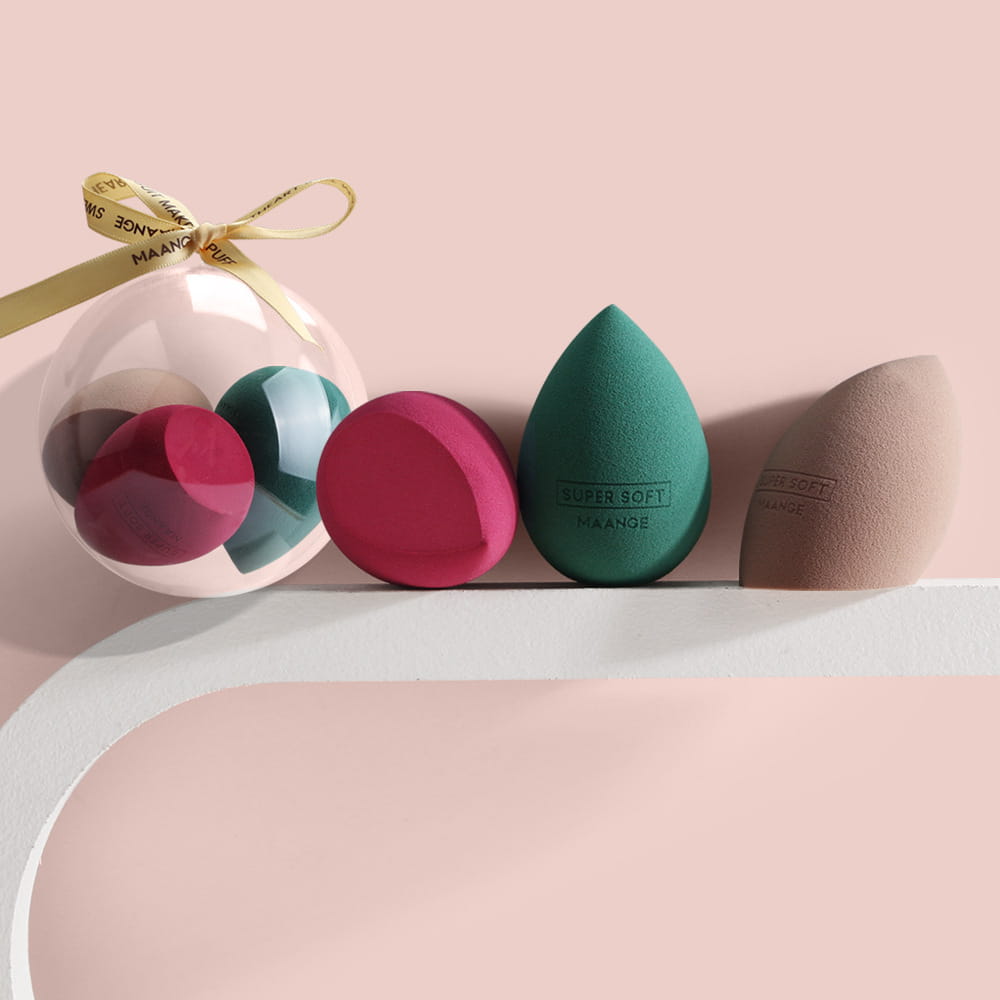 Set of four colorful spherical beauty egg makeup sponges in pink teal and beige with a soft texture for flawless makeup application.
