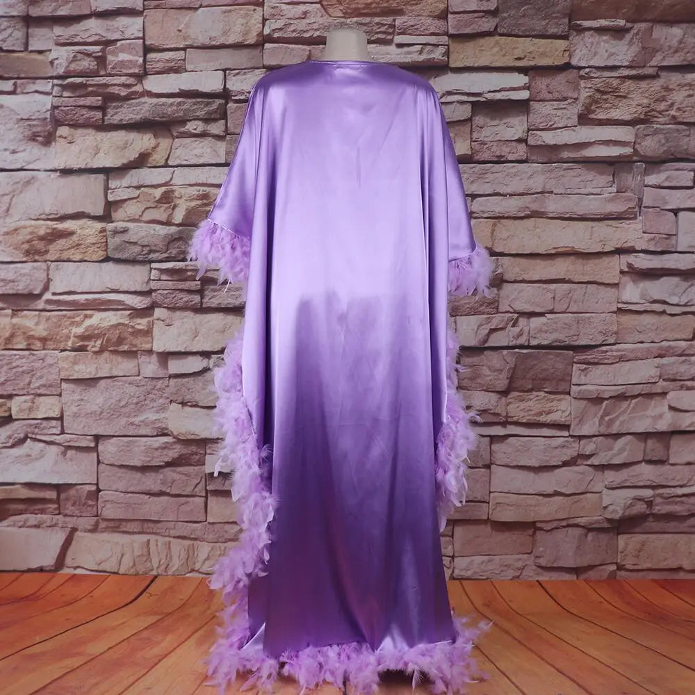 A flowing lavender satin abaya with delicate feather trim along the sleeves and hem exemplifies a loose dress luxury fully designed for elegant occasions.