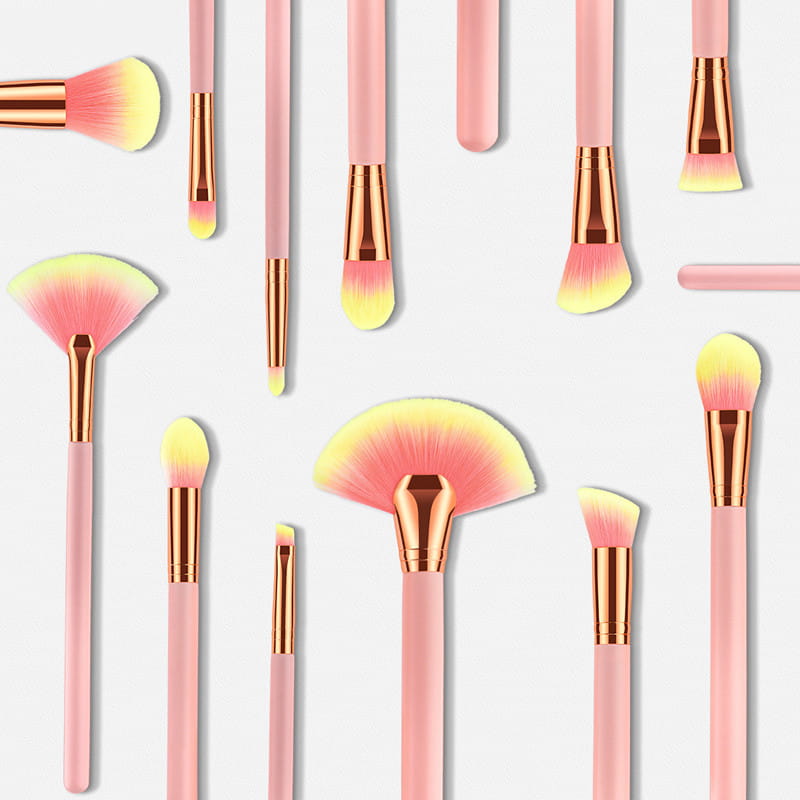 Set of 12pcs beauty makeup brushes featuring pink and rose gold handles with gradient yellow bristle tips for professional makeup application.