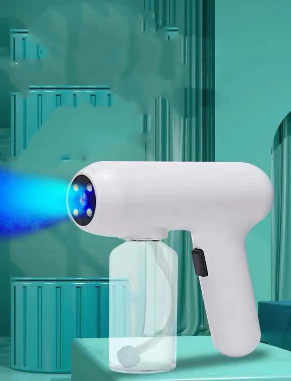 K5 Pro electric sanitizer sprayer white handheld disinfection gun with a transparent liquid reservoir and blue light emitting from its circular nozzle.