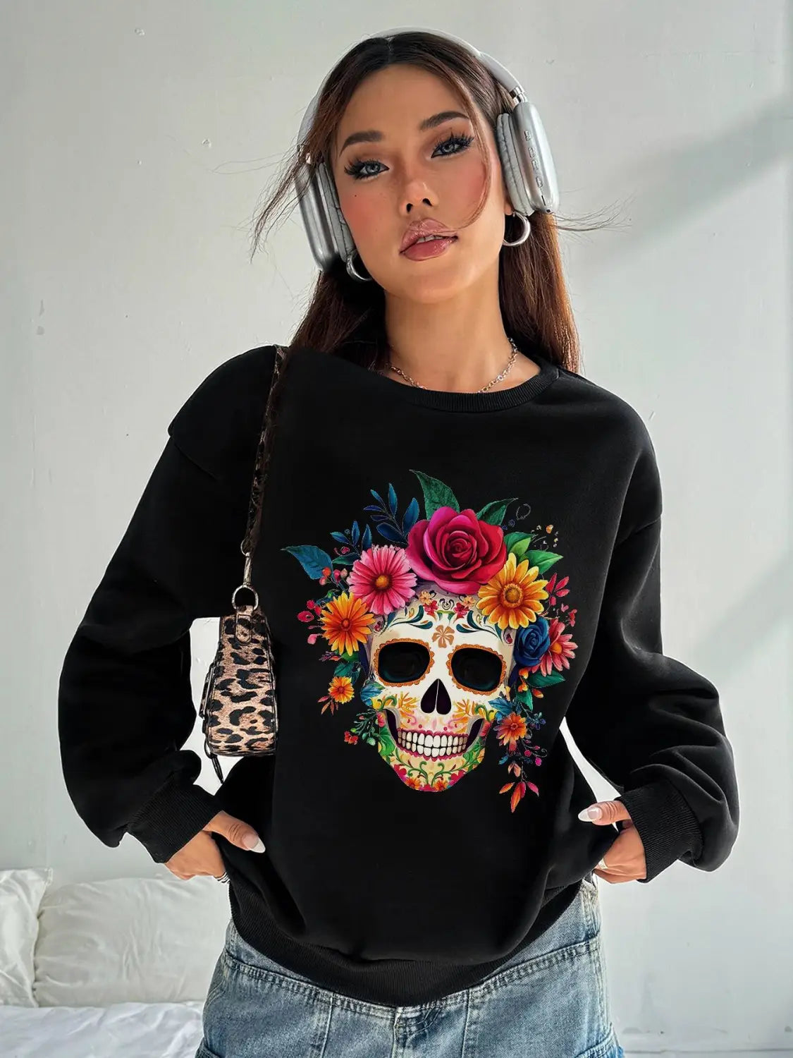 Black crew neck sweatshirt for daily wear featuring a vibrant colorful sugar skull design adorned with roses and flowers on the front.