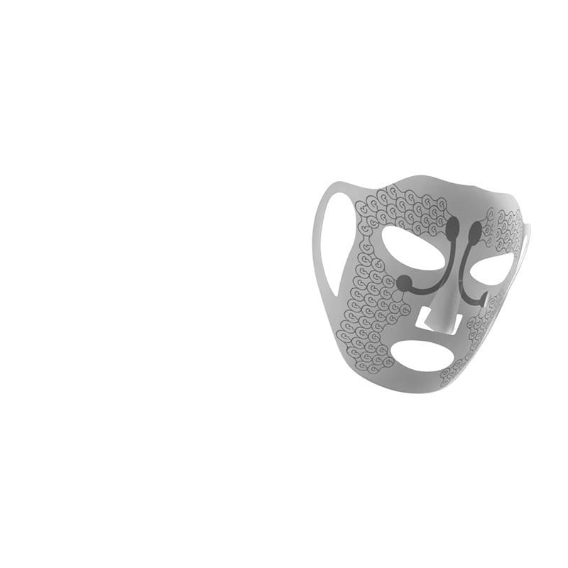 Silver metallic electric facial massage mask with intricate swirling lace patterns and stylized facial cutouts designed for effective massage mask face treatment.
