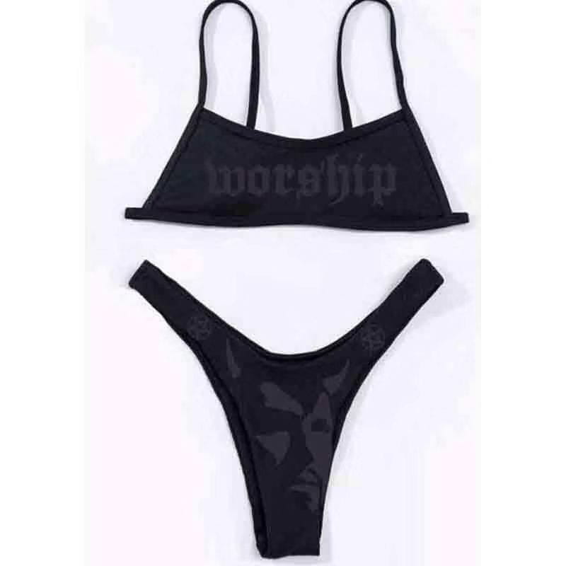 black bikini set featuring dark offset printing with worship printed on the top and a face design on the bottom in an offset printing split bikini swimsuit