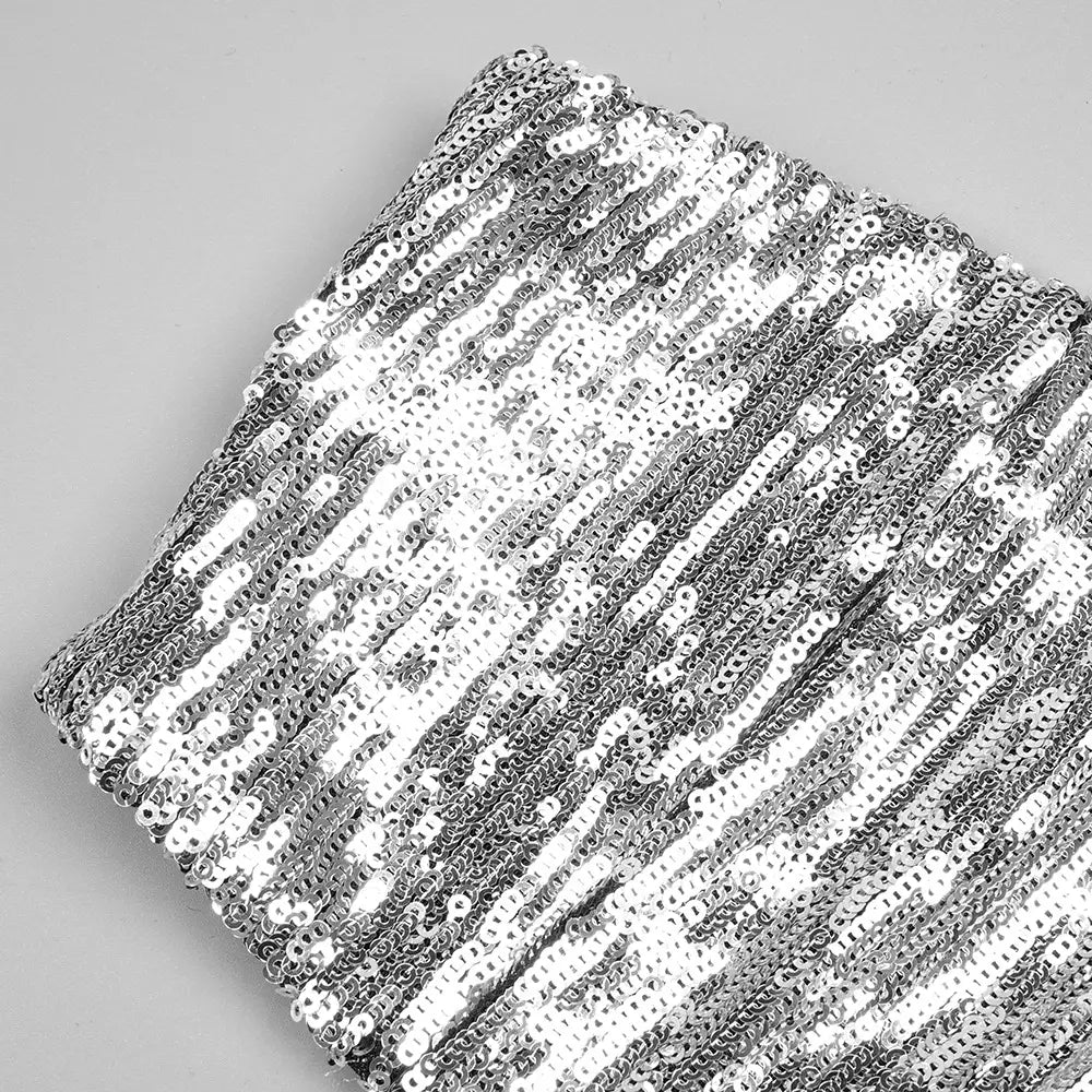 a silver strapless sequin skirt set featuring a shimmering silver sequin skirt with a dense reflective surface and uniform oval-shaped embellishments