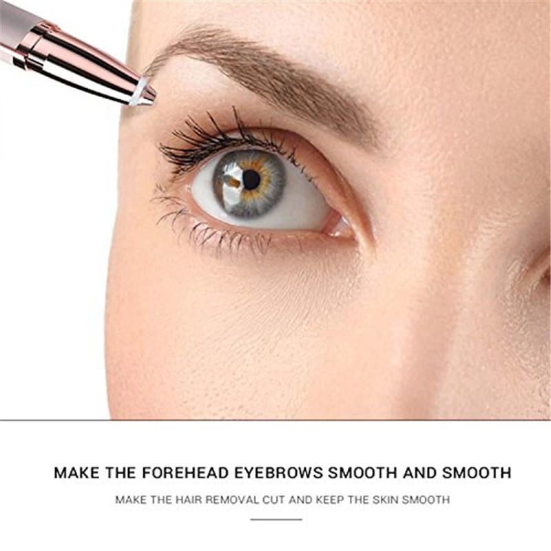 A sleek rose gold and silver flawlessly brows electric eyebrow remover with a fine tip positioned near the forehead for precise trimming.