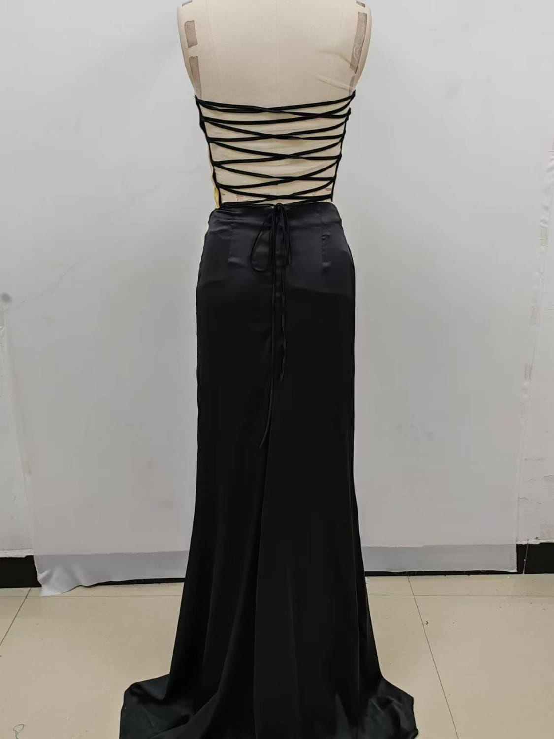 black satin maxi skirt with high-waisted fitted silhouette and back tie closure as part of one-shoulder slit mop black dress two-piece set featuring set sexy lacing detail