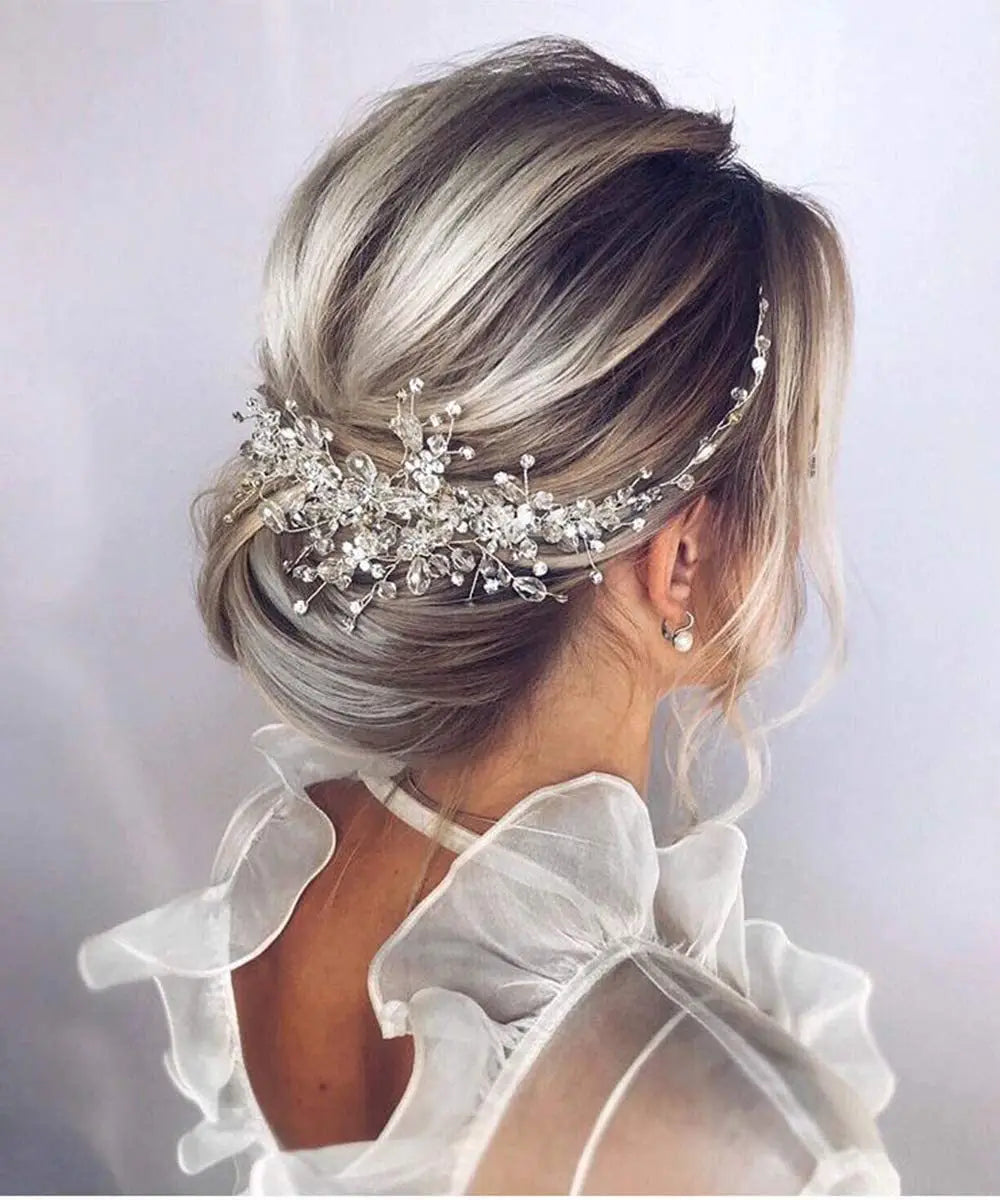 a delicate silver crystal gauze hair accessory adorned with sparkling rhinestones and intricate leaf-like designs elegantly securing a soft blonde updo as gauze dress accessories headdress