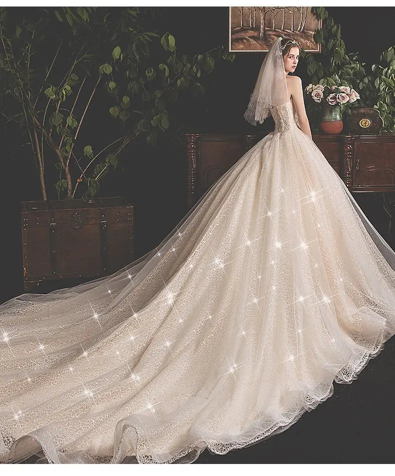 an ivory lace bride summer tube top mori style trailing skirt wedding gown with a voluminous skirt and an attached veil