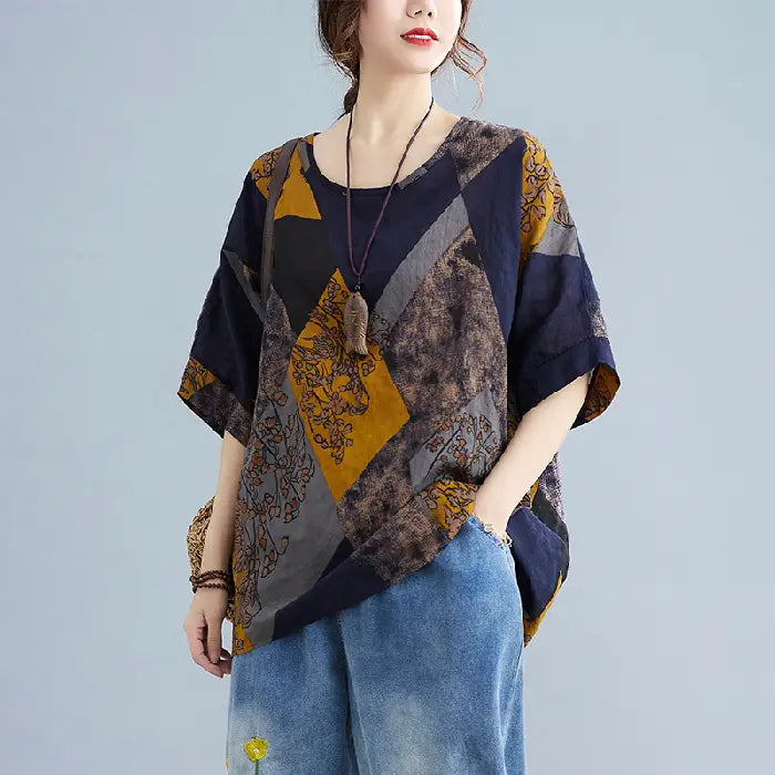 Stylish loose round neck printed patchwork blouse in navy blue mustard yellow and gray featuring floral and geometric patterns.