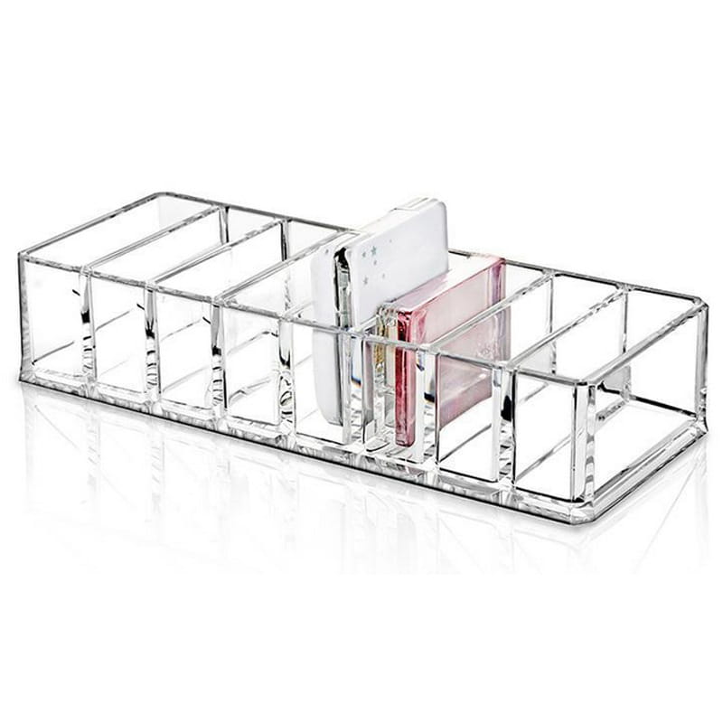Clear acrylic makeup organizer with multiple compartments holding a white phone and pink card in a makeup organizer image.