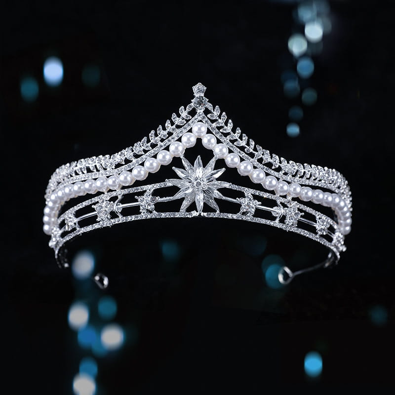 a sparkling silver bridal crown baroque tiara with intricate crystal detailing rows of lustrous white pearls and a central starburst design