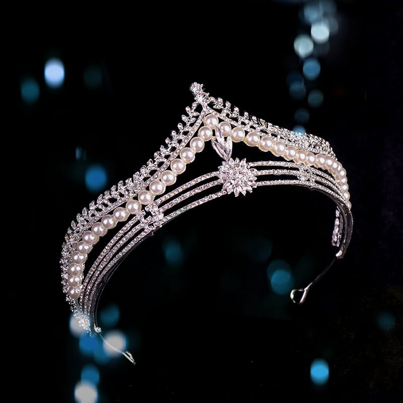 A sparkling silver bridal crown baroque featuring rows of lustrous white baroque pearls and intricate crystal embellishments.