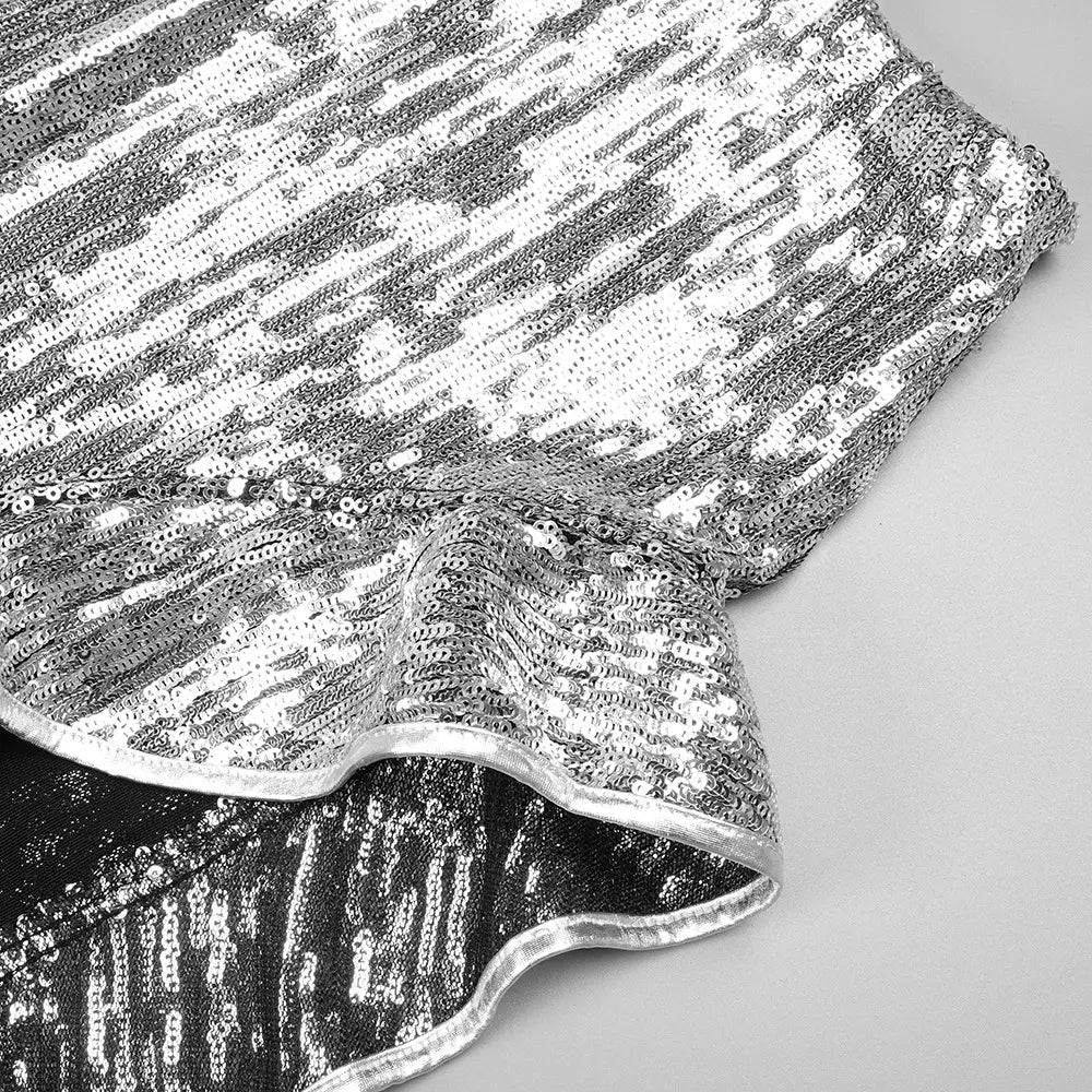silver strapless sequin skirt set featuring a shimmering silver sequined ruffle detail with a dense pattern of reflective metallic beads on the skirt set.
