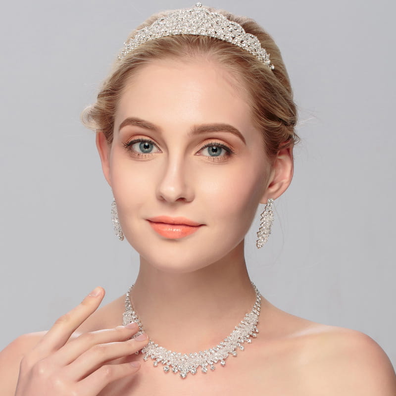 A sparkling silver tiara with intricate crystal embellishments and a delicate regal design from the silver crystal choker wedding jewelry set.