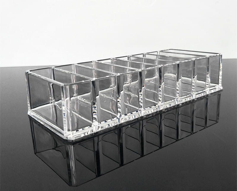 Clear acrylic makeup organizer with ten rectangular compartments for efficient cosmetic storage in a makeup organizer image.