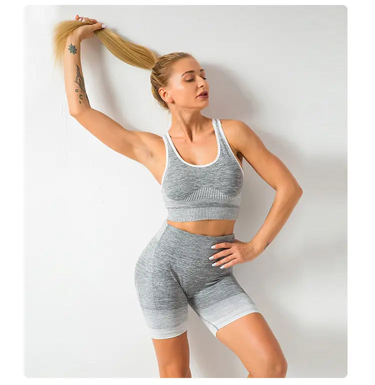Gray heathered two-piece seamless yoga set for women with white trim and hip lifting design ideal for workout sessions