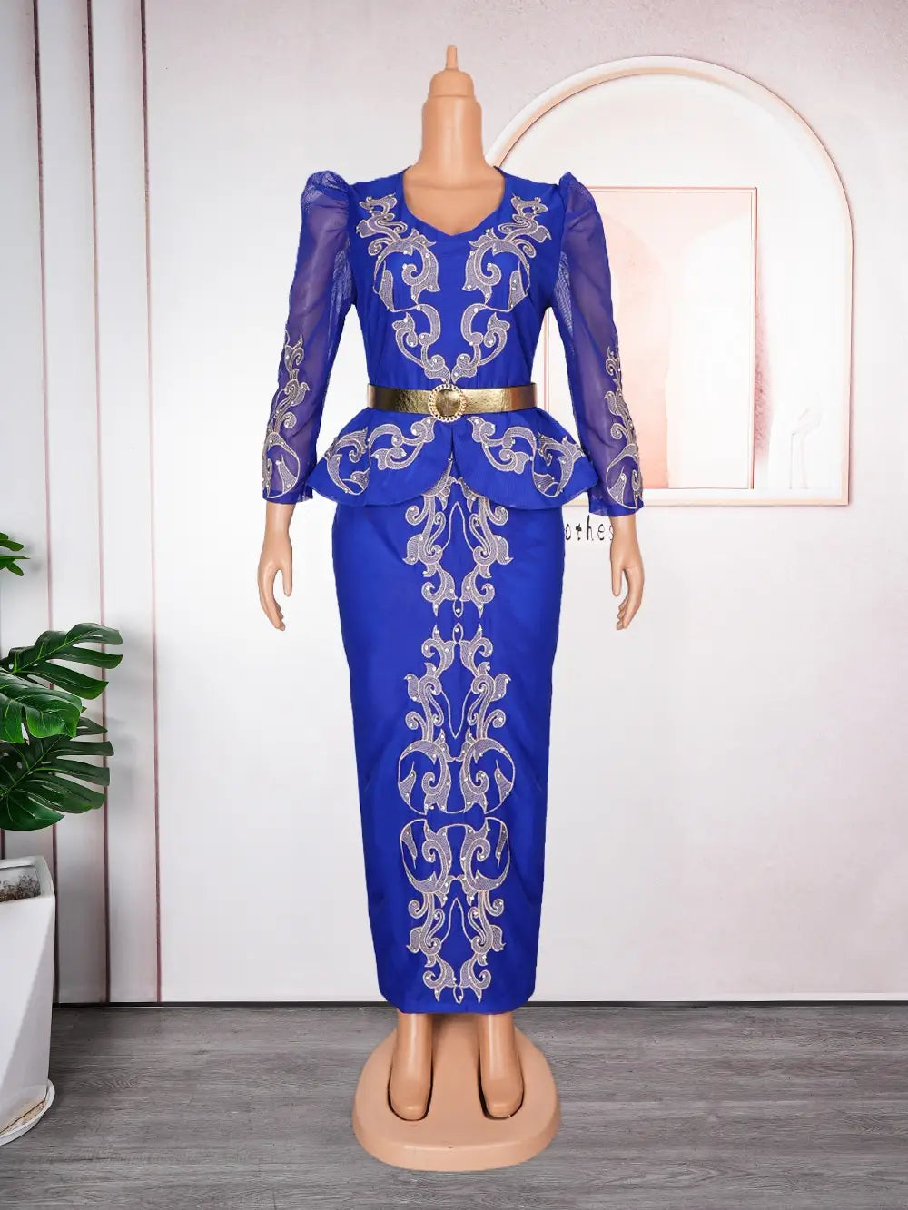 Luxury rhinestone beaded royal blue two-piece outfit featuring intricate silver embroidery, sheer long sleeves, and a gold belt for formal occasions.