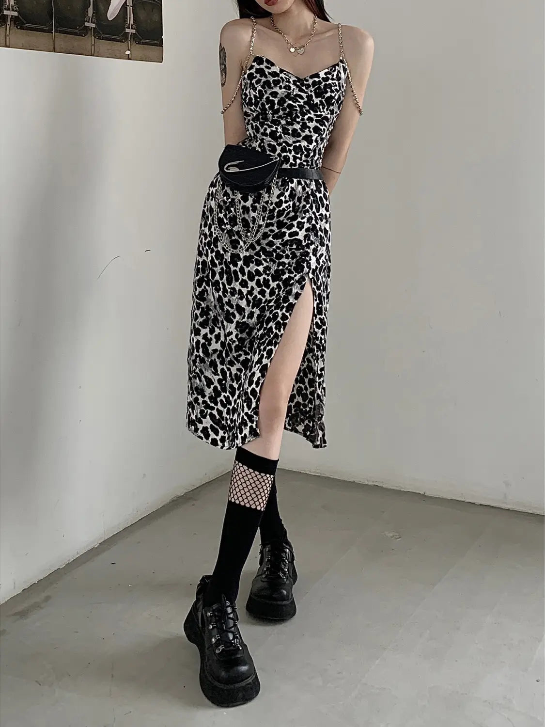 Black and white dark sexy leopard print satin slip dress featuring a fitted bodice, thin spaghetti straps, and a high slit.