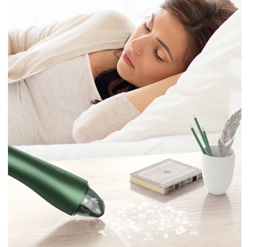 Green wireless vacuum cleaner for car and household with sleek modern design and transparent dust collection tip.