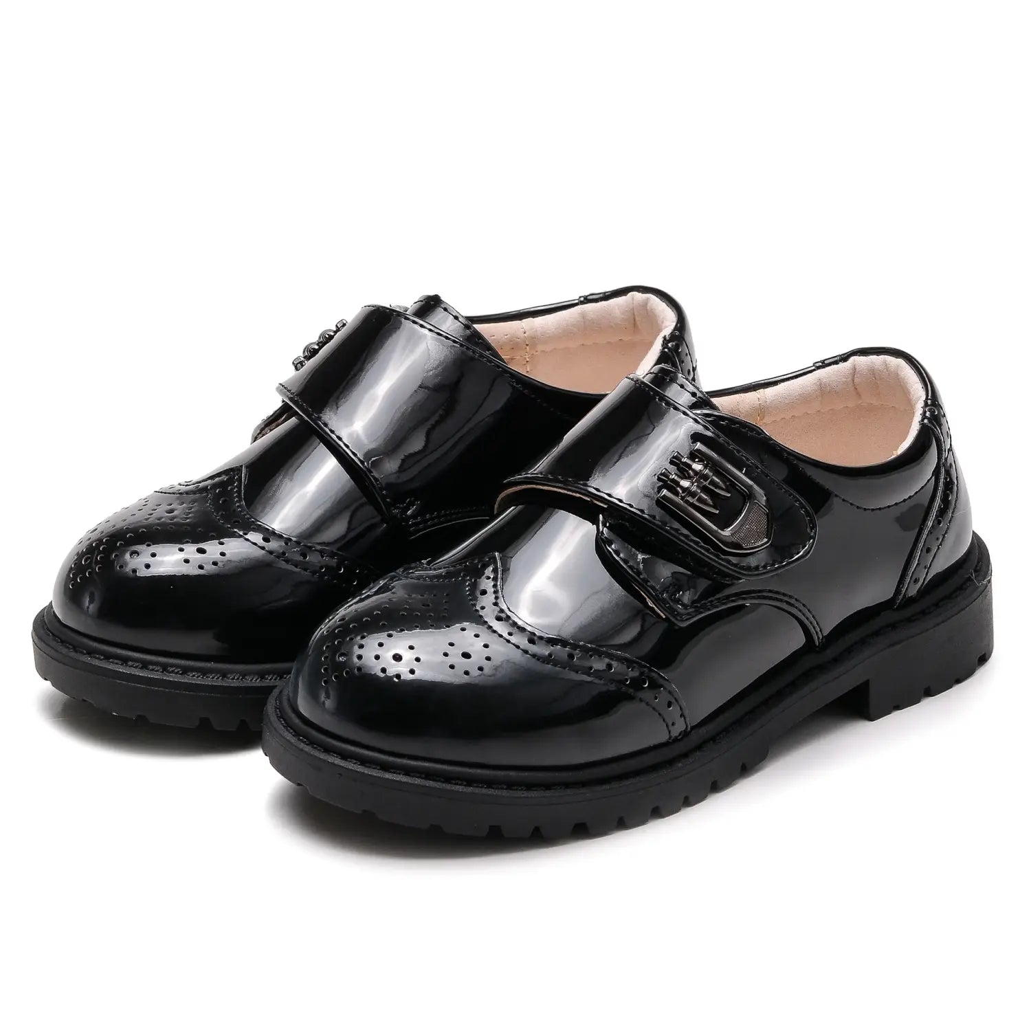 Boys black patent leather shoes with brogue detail feature velcro straps and a chunky rubber sole for a british casual single style.