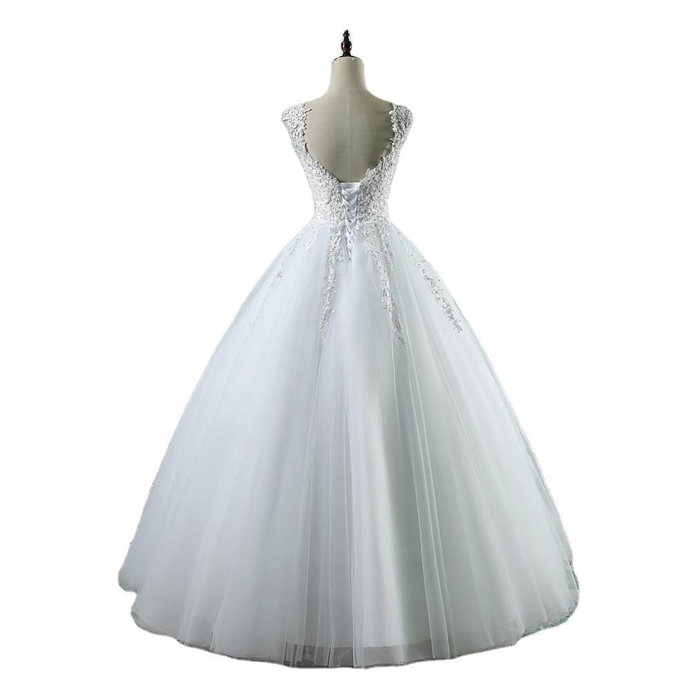 White lace v neck high waist wedding dress with delicate lace detailing and a voluminous tulle skirt for an elegant waist wedding dress look.