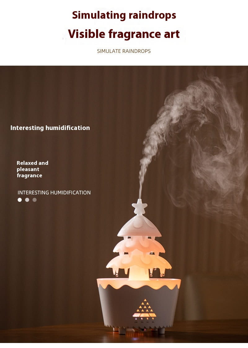 white and gray christmas tree-shaped essential oil aroma diffuser humidifier with glowing base emitting mist for design essential oil use