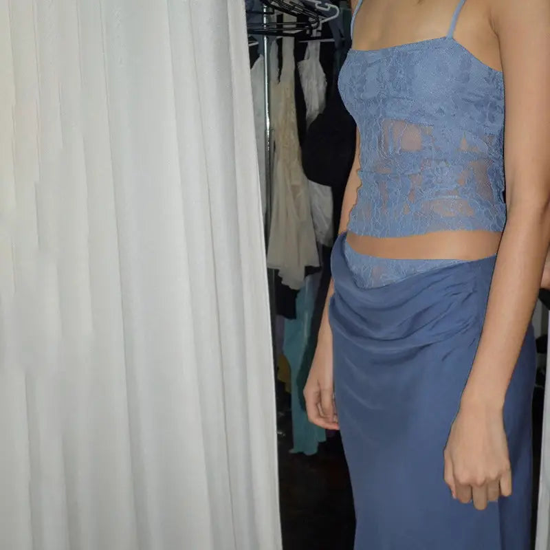 a delicate blue lace backless tube crop top with thin straps paired with a matching sage green sling stitching ruffle hip skirt