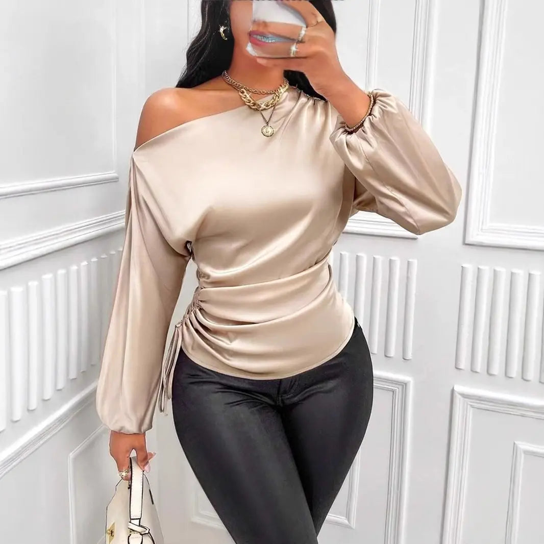 Beige satin off-shoulder top with long sleeves and a ruched waist highlighting a satin shirt asymmetric style in a shirt asymmetric long design.