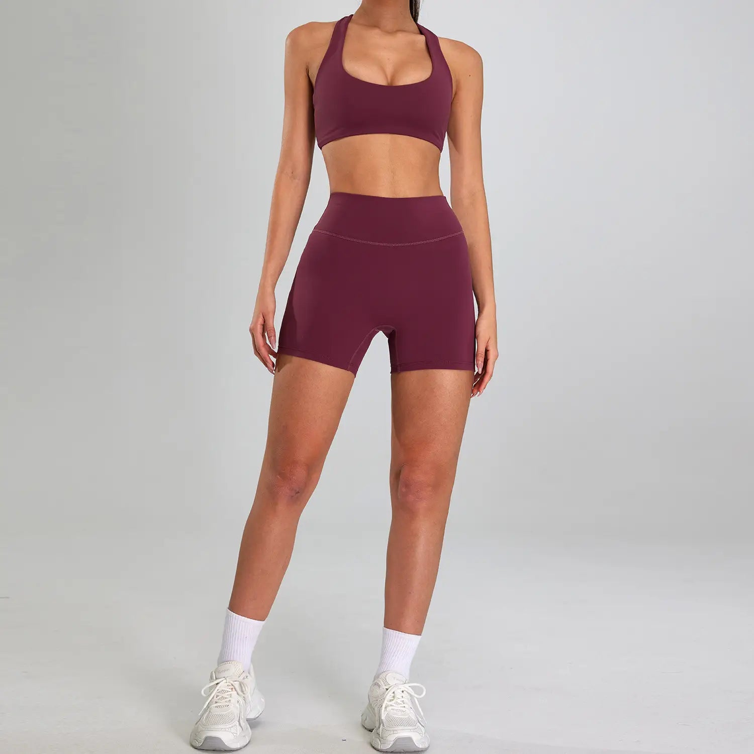 Maroon high-waisted athletic shorts with seamless stretchy fabric finish designed for outdoor running nude and sports suit outdoor activities.
