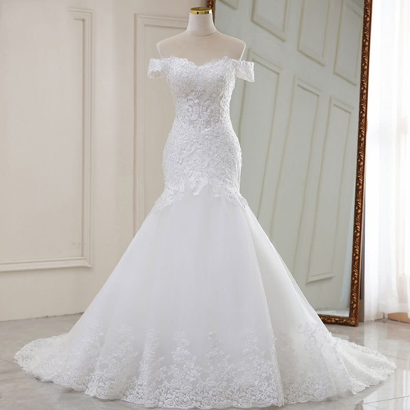 A high waist white lace mermaid wedding dress with intricate lace detailing and a flowing tulle skirt made from polyvinyl alcohol fiber.