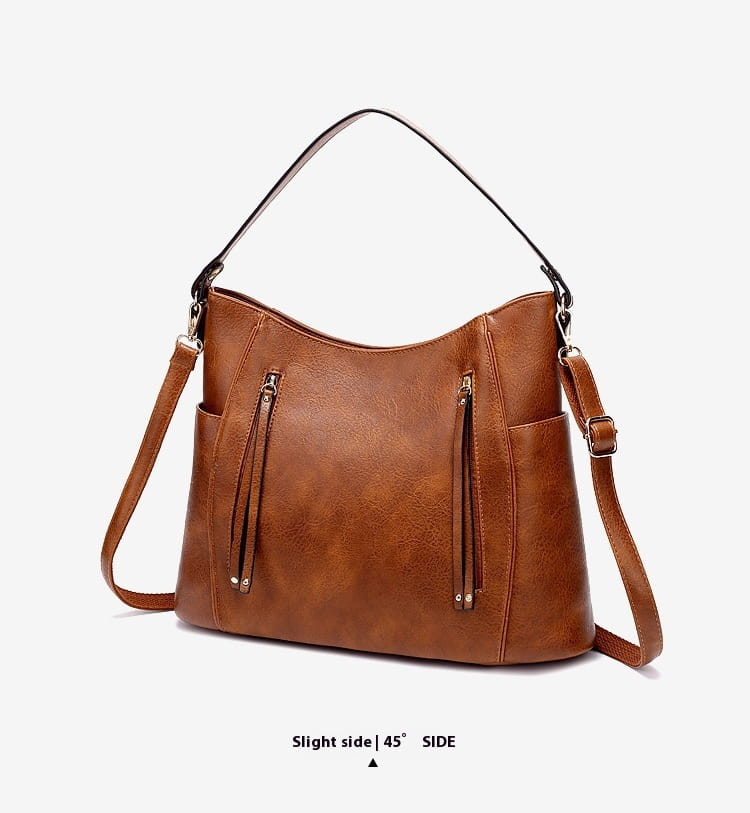 Brown faux leather large capacity luxury women leather hobo bag with black shoulder strap and adjustable crossbody strap.