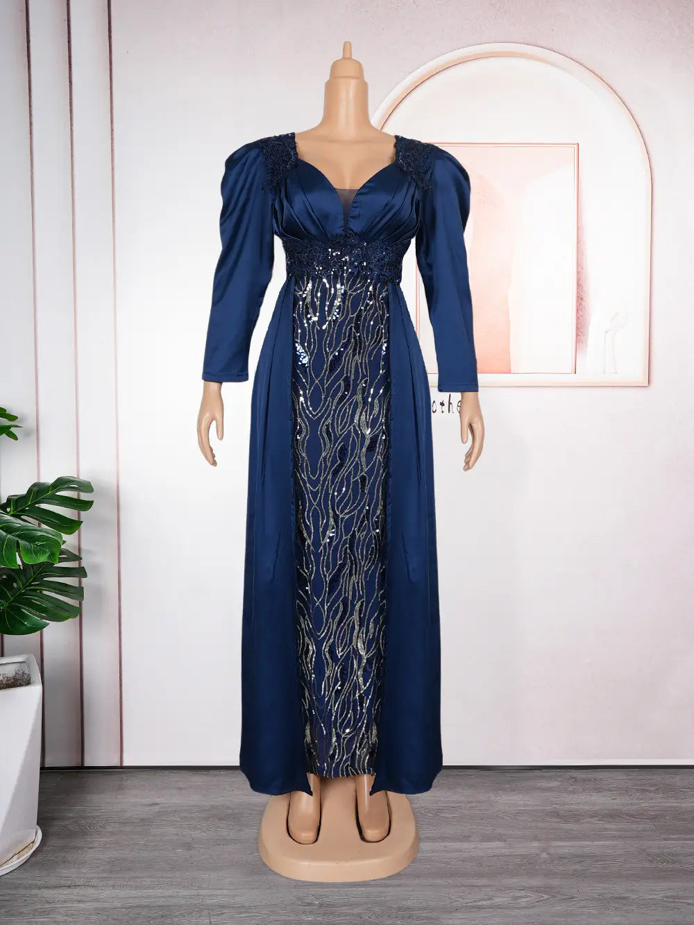 A navy blue satin plus size evening dress with puffed sleeves and a backless sequined bodice displayed on a mannequin.