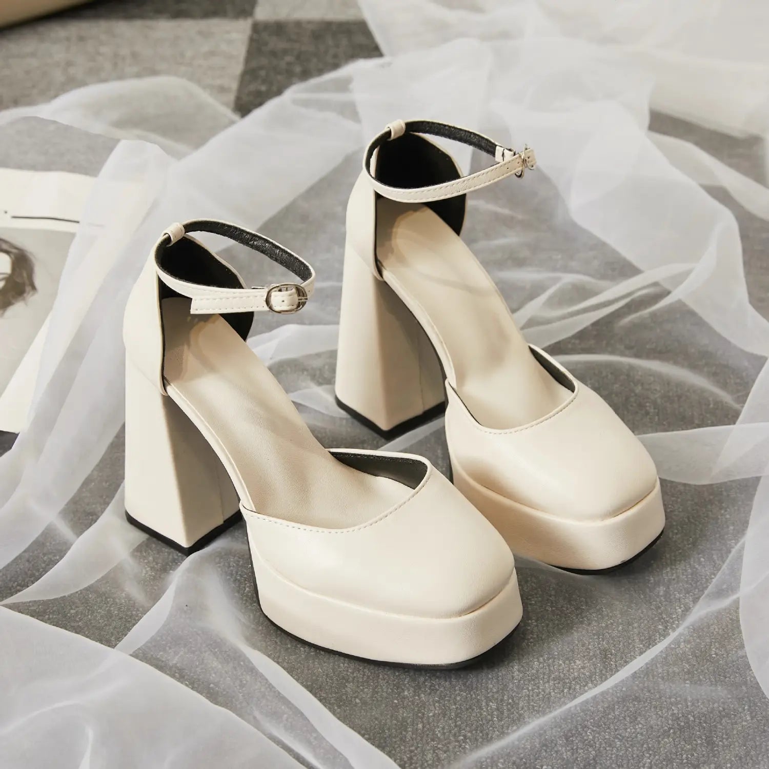 Cream-colored white patent super high heel platform mary janes with chunky block heel and ankle strap