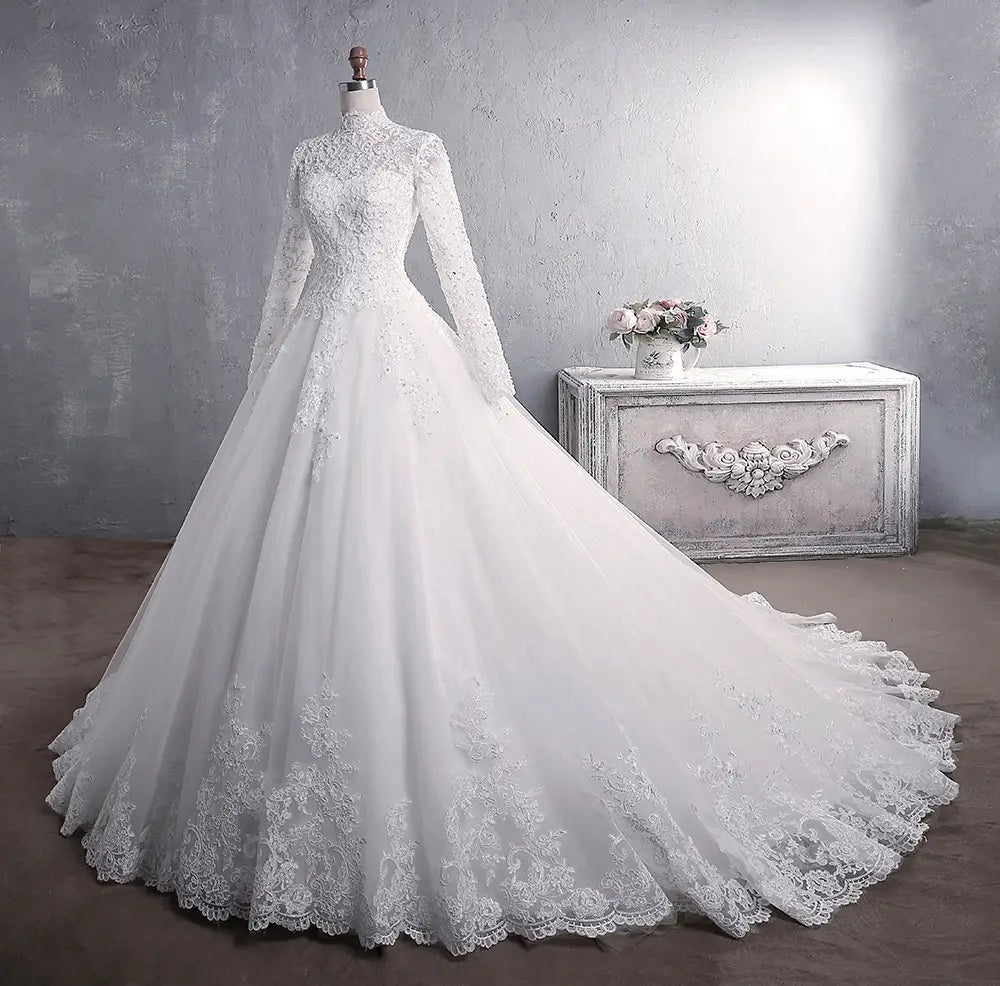 Elegant white lace wedding dress bridal gown with long sleeves and intricate lace detailing featuring a large tail.