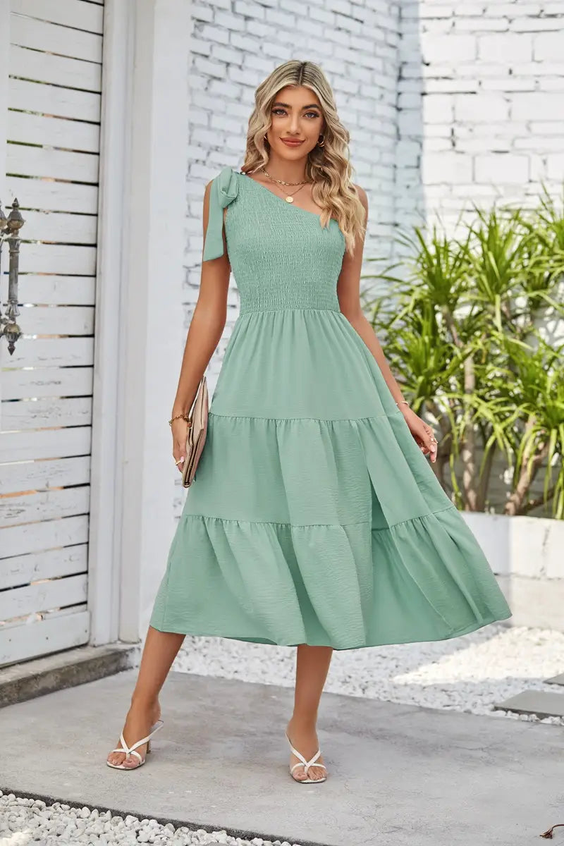 a mint green tiered midi dress featuring a one-shoulder design and subtle texture with a pleated layered hem and elegant hem split dress detail