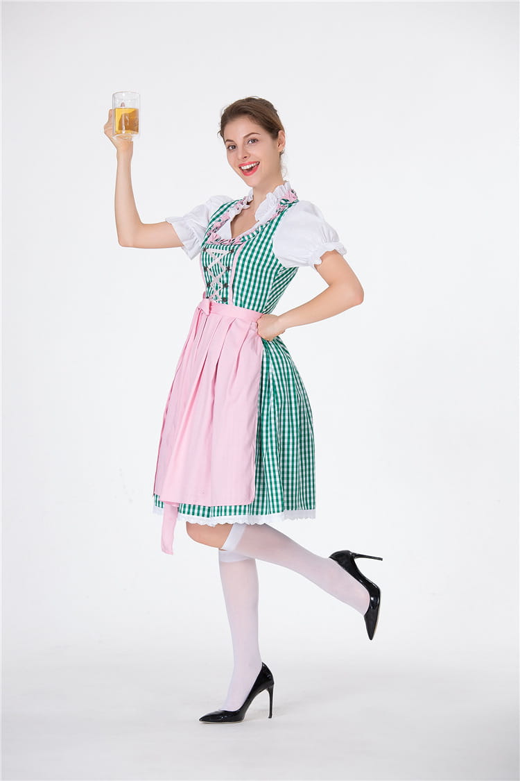 A woman wearing a green and white checkered dirndl dress with a pink apron and black high heels suitable for german beer festival clothing and american german beer events.