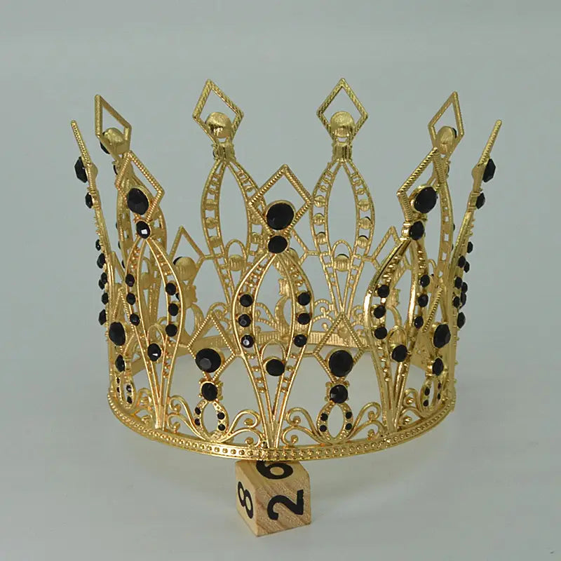 baroque golden birthday crown cake decoration featuring a gold-colored ornate tiara with black gemstones and intricate filigree detailing
