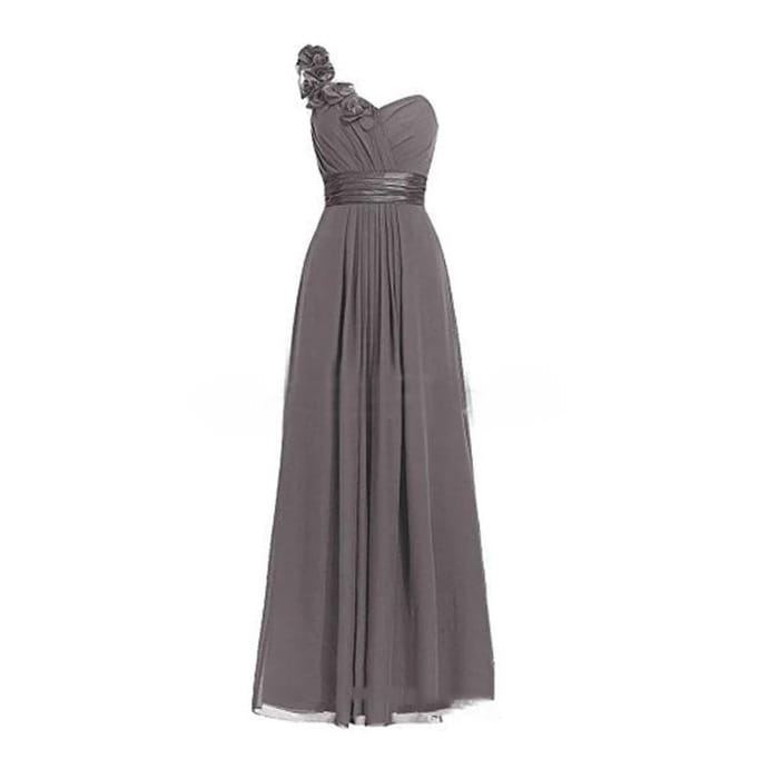 a flowing gray chiffon maxi dress with a slanted neck sleeveless design, featuring an embellished floral accent at the shoulder and a metallic belt cinching the waist in a lavender multi colored style